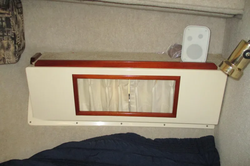 Slide: The Image of Interior of 2005 Camano Troll Flybridge with speaker and wooden panel. - 39