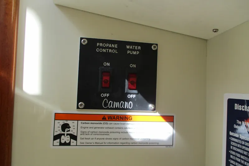 Slide: The Image of Control panel with propane and water pump switches on a 2005 Camano Troll Flybridge. - 40