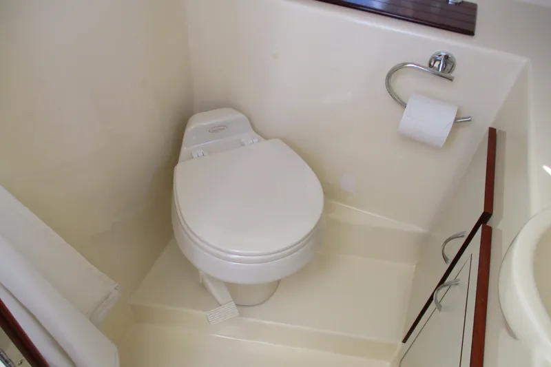 Slide: The Image of Compact bathroom in 2005 Camano Troll Flybridge boat with toilet and storage cabinet. - 42