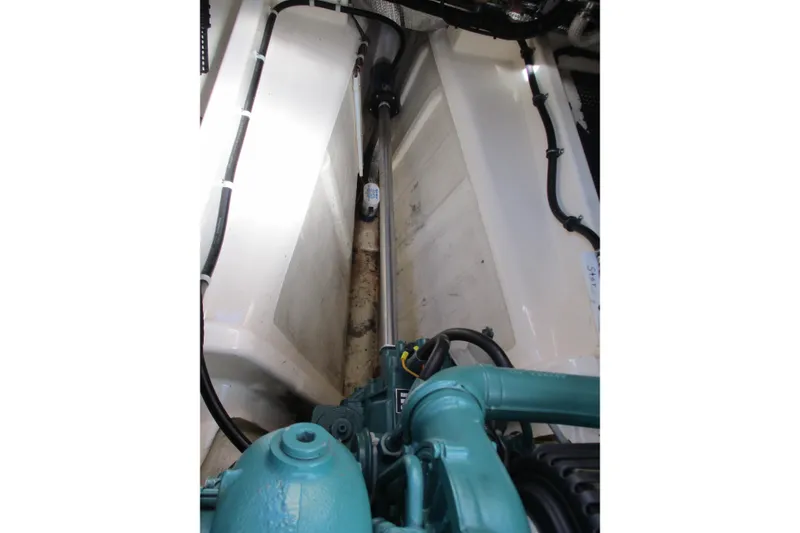 Slide: The Image of Engine compartment of 2005 Camano Troll Flybridge boat, showcasing mechanical components and wiring. - 44