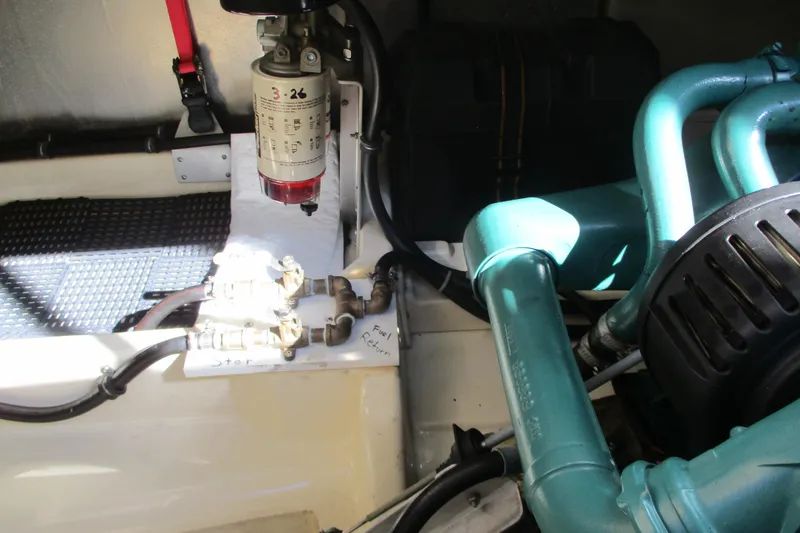 Slide: The Image of Engine compartment of a 2005 Camano Troll Flybridge boat, showing fuel system components. - 45