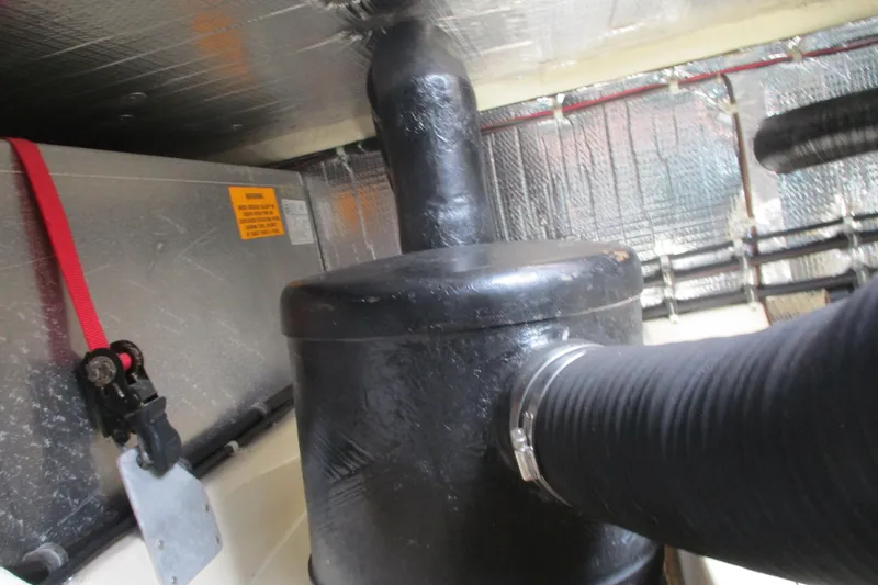 Slide: The Image of Engine compartment of 2005 Camano Troll Flybridge with insulated pipes and components. - 46