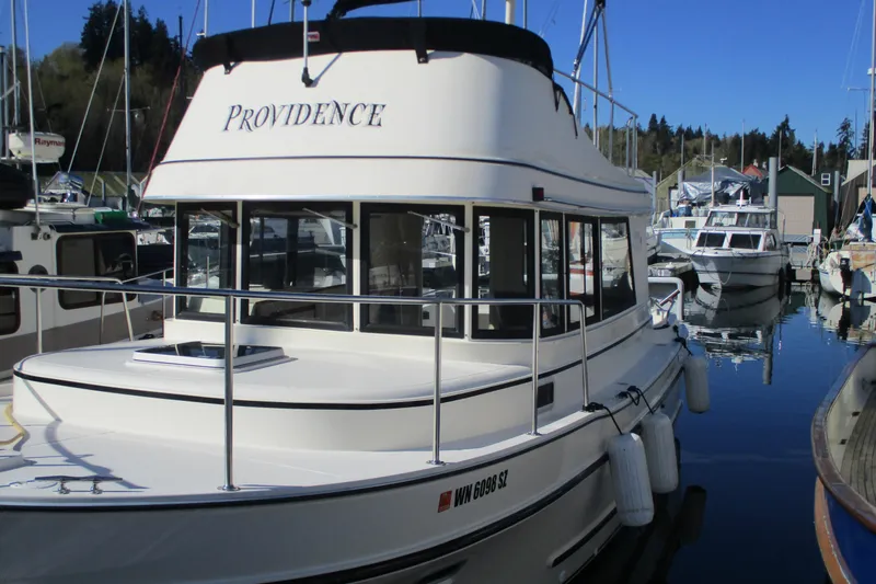 Slide: The Image of 2005 Camano Troll boat named "Providence" docked at a marina. - 5