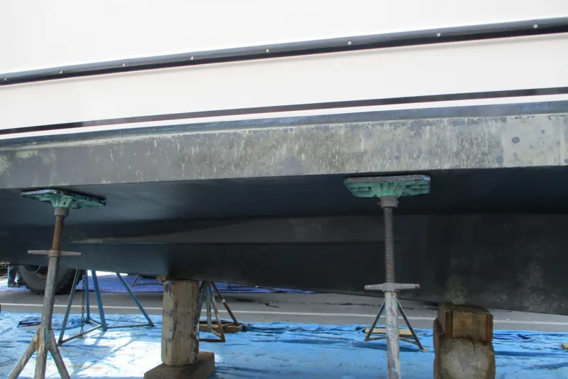 Slide: The Image of 2005 Camano Troll Flybridge boat hull on supports during maintenance. - 53