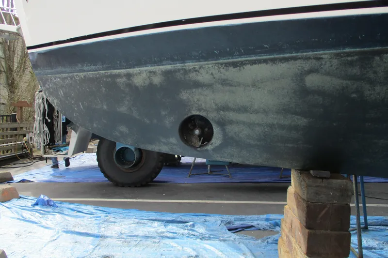 Slide: The Image of 2005 Camano Troll Flybridge boat hull on blocks, undergoing maintenance. - 60