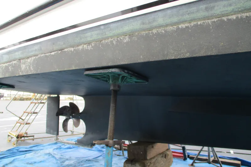 Slide: The Image of 2005 Camano Troll Flybridge boat hull and propeller during maintenance. - 61
