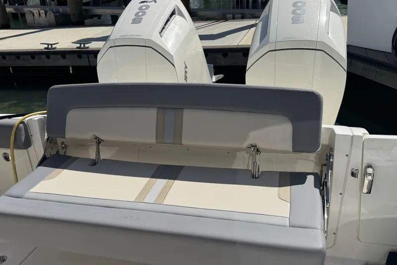 Slide: The Image of 2024 Boston Whaler 380 Realm boat with dual Mercury engines at dock. - 3