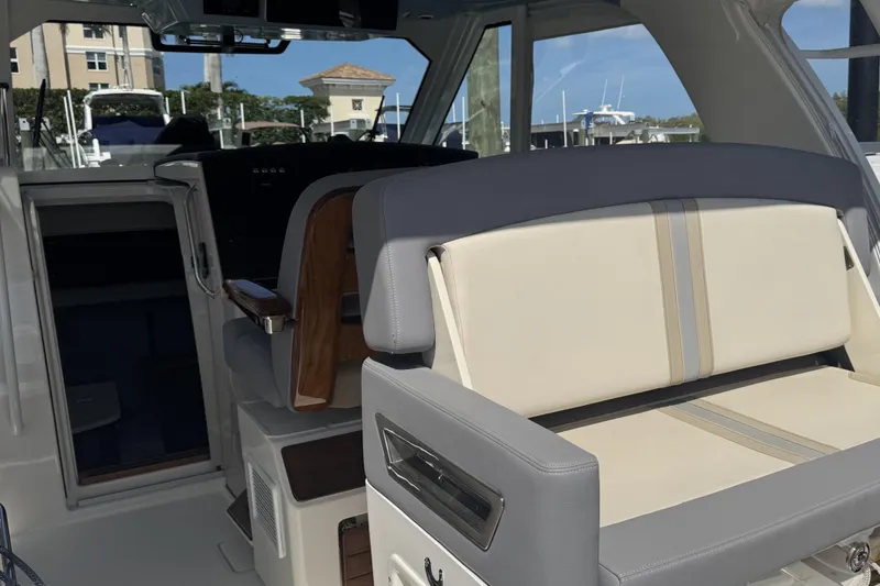 Slide: The Image of Interior view of 2024 Boston Whaler 380 Realm boat, featuring luxurious seating and helm area. - 5