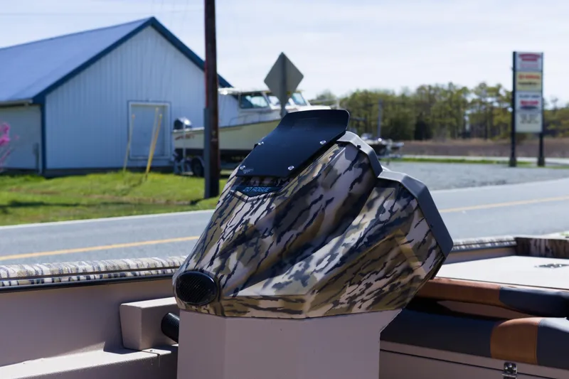 Slide: The Image of Camouflage console of Avid 20 Rogue SC boat, 2026 model, parked near a road. - 11