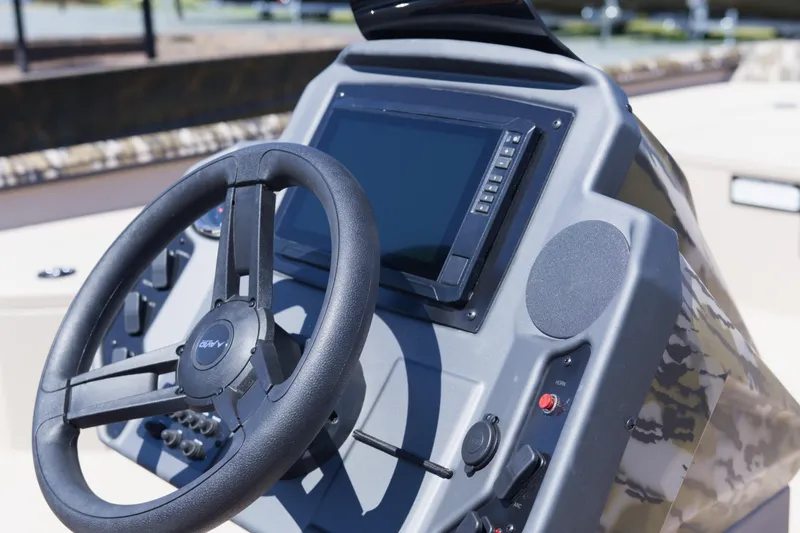 Slide: The Image of Steering console of 2026 Avid 20 Rogue SC boat with modern controls and display. - 12