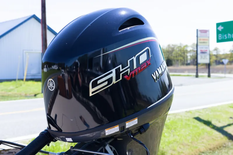 Slide: The Image of Outboard motor on Avid 20 Rogue SC, 2026 model, parked near road. - 4