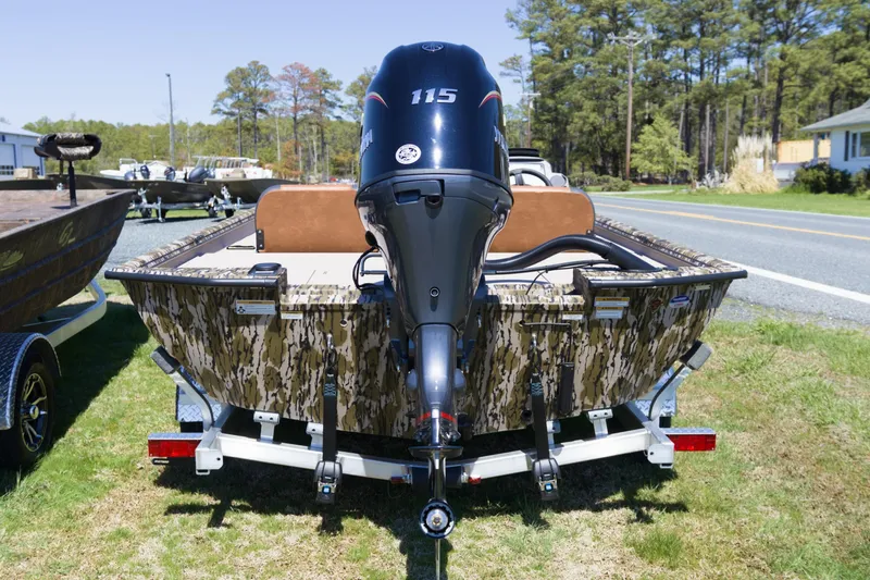 Slide: The Image of 2026 Avid 20 Rogue SC boat with camouflage design and powerful outboard motor. - 7