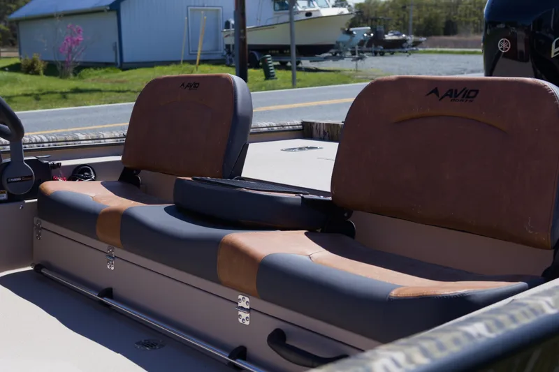 Slide: The Image of 2026 Avid 20 Rogue SC boat interior with brown and gray seating. - 8
