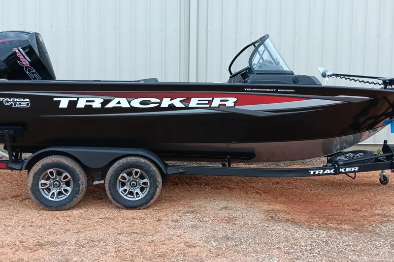 The Image of 2026 Tracker Targa V-19 WT boat on trailer, black with red accents, parked outdoors. - 0