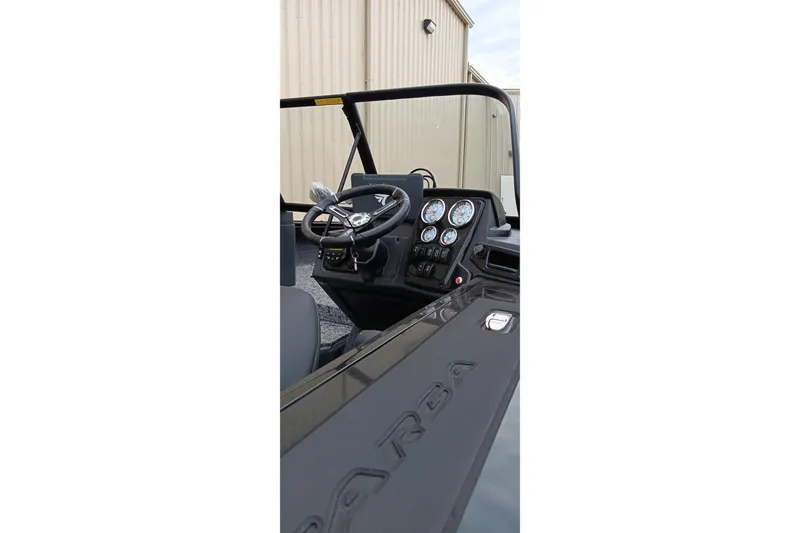 Slide: The Image of 2026 Tracker Targa V-19 WT boat dashboard with steering wheel and gauges. - 11
