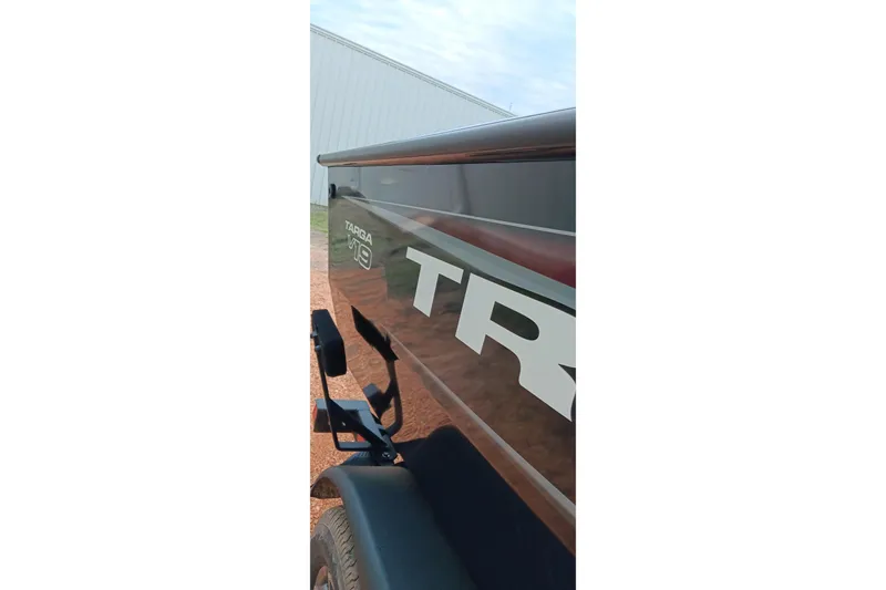 Slide: The Image of 2026 Tracker Targa V-19 WT boat side view with logo and trailer. - 16
