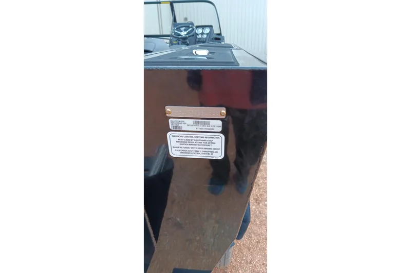 Slide: The Image of 2026 Tracker Targa V-19 WT boat with visible identification and emission control labels. - 2