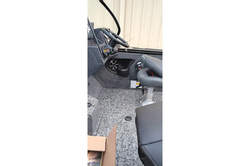 Slide: The Image of Interior of 2026 Tracker Targa V-19 WT boat with steering wheel and seating. - 21