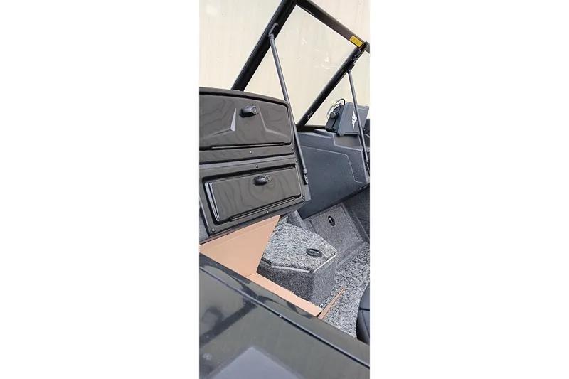 Slide: The Image of 2026 Tracker Targa V-19 WT boat interior with storage compartments and carpeted flooring. - 22