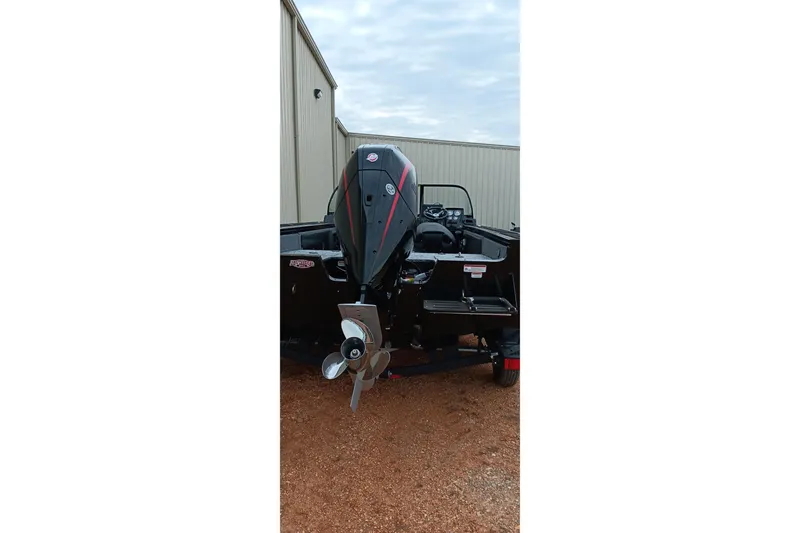 Slide: The Image of 2026 Tracker Targa V-19 WT boat with powerful outboard motor, parked outdoors. - 6