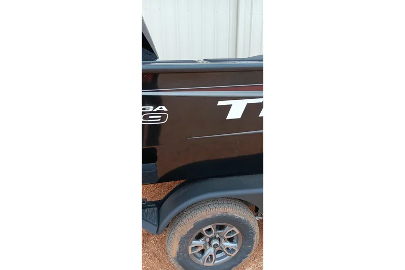 Slide: The Image of 2026 Tracker Targa V-19 WT boat side view with visible tire and logo. - 9