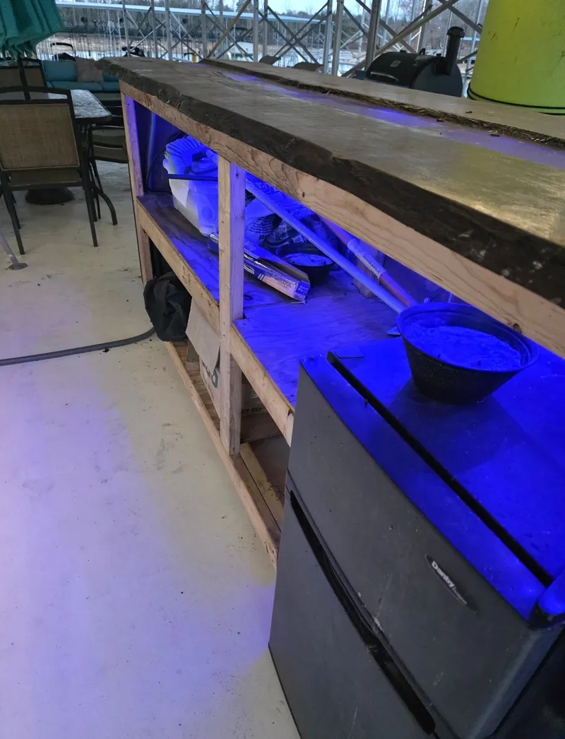 Slide: The Image of Wooden countertop with blue lighting and fridge, STARDUST 53, 1992. - 12