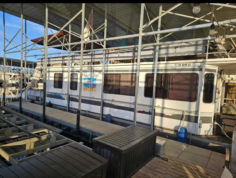 Slide: The Image of 1992 STARDUST 53 houseboat docked in covered marina. - 2