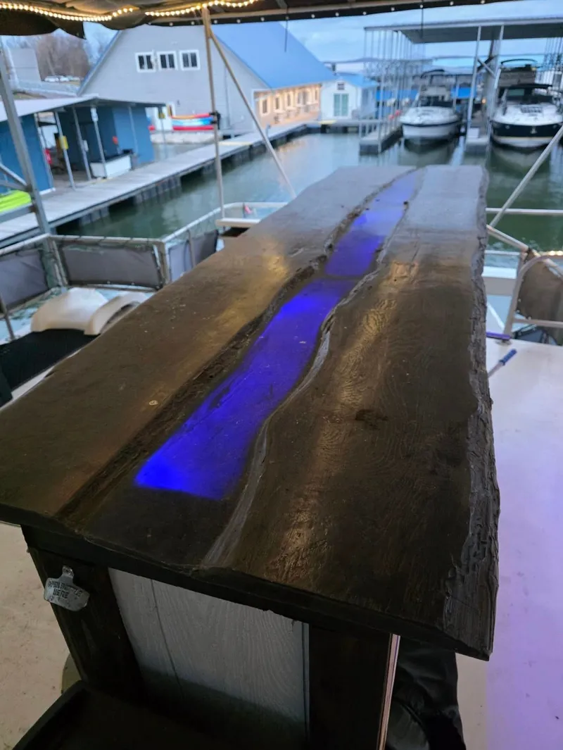 Slide: The Image of Wooden table with blue LED light, marina in the background. - 20