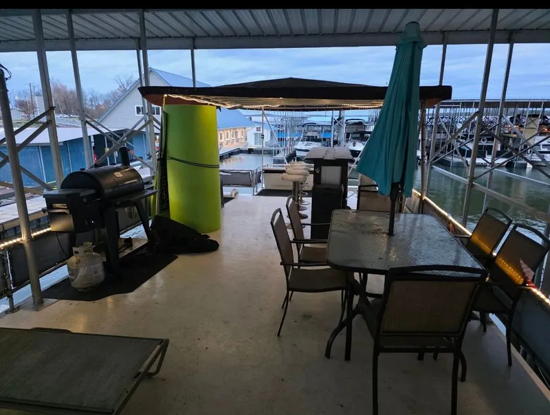 Slide: The Image of Houseboat deck with grill, table, and chairs, STARDUST 53, 1992. - 22