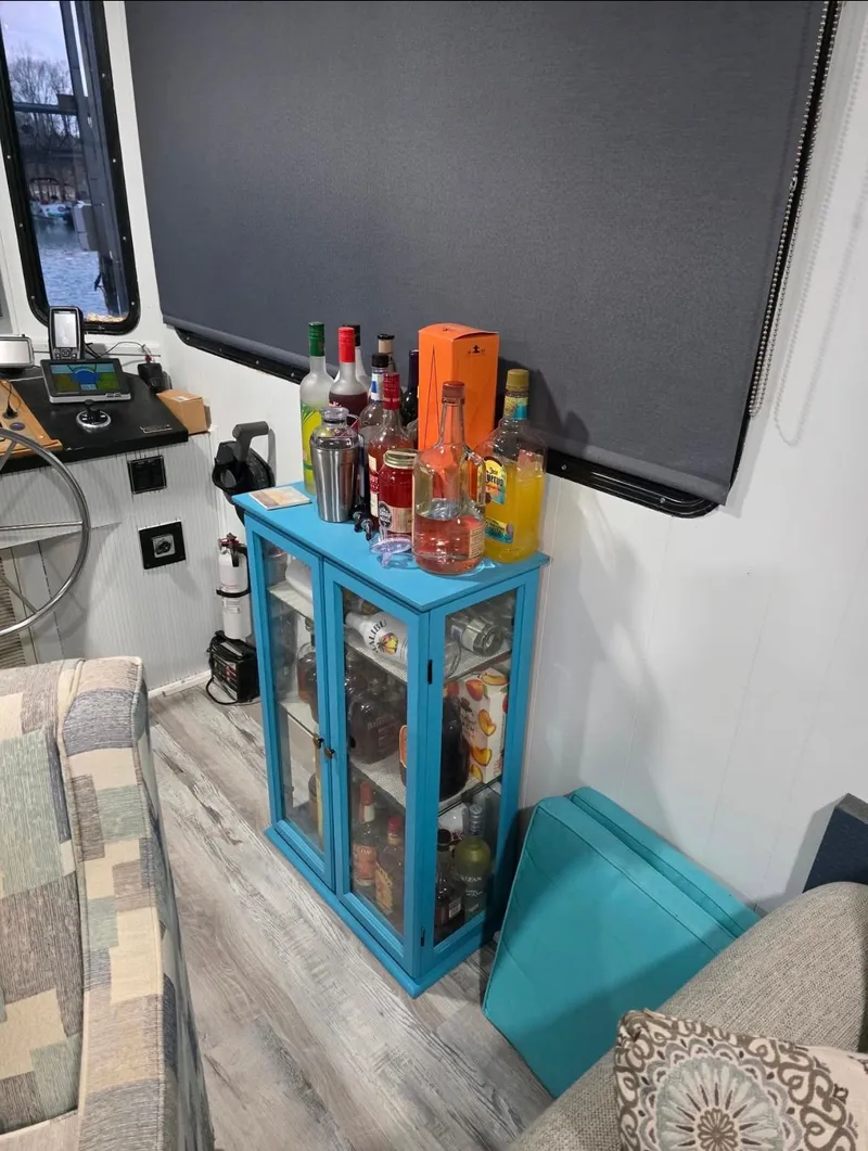 Slide: The Image of Houseboat bar with blue cabinet and liquor bottles, STARDUST 53, 1992. - 26