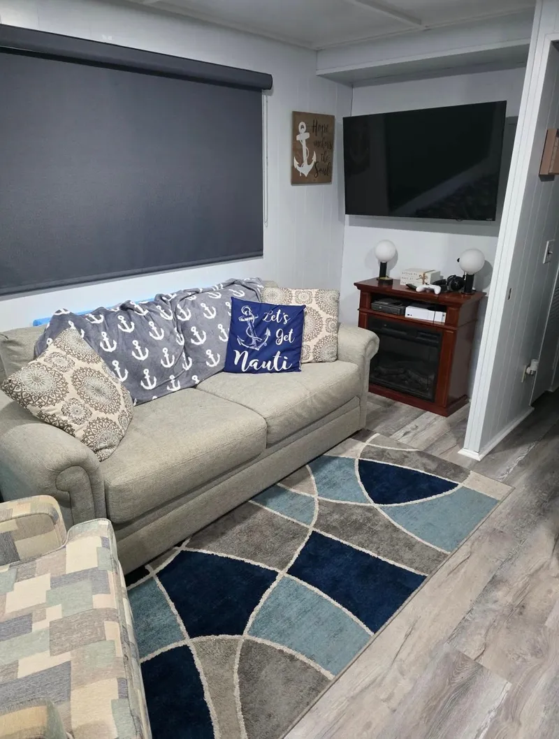 Slide: The Image of Cozy living room with gray sofa and nautical pillows, STARDUST 53, 1992. - 31