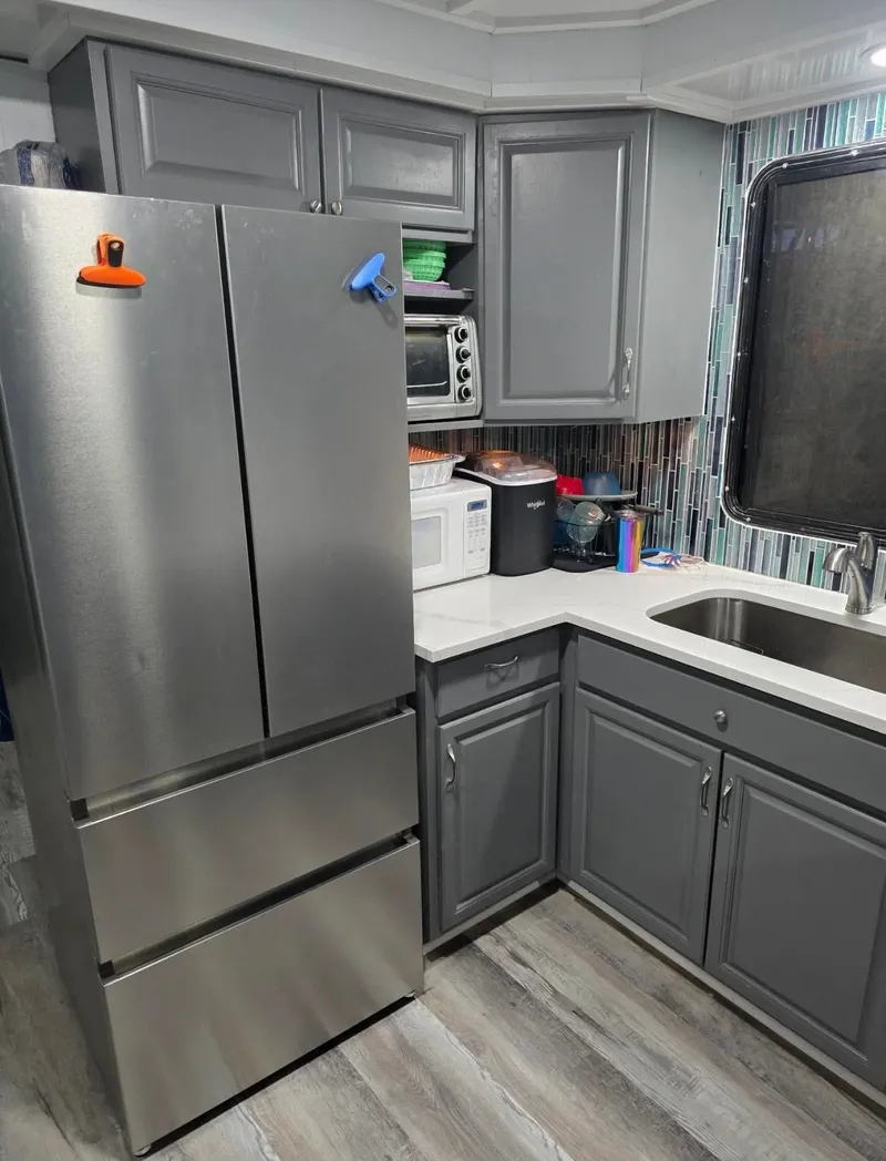 Slide: The Image of Modern gray kitchen with stainless steel fridge and appliances. - 34