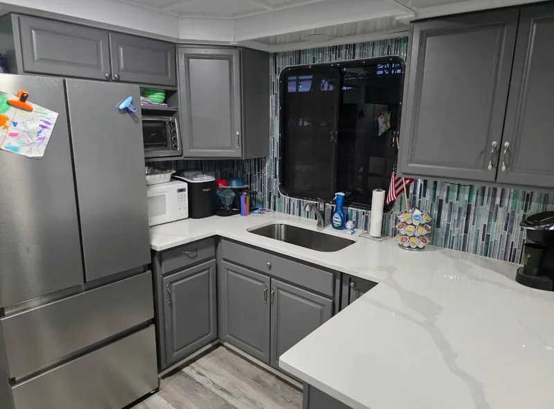 Slide: The Image of Modern kitchen with gray cabinets and marble countertops, STARDUST 53, 1992. - 41