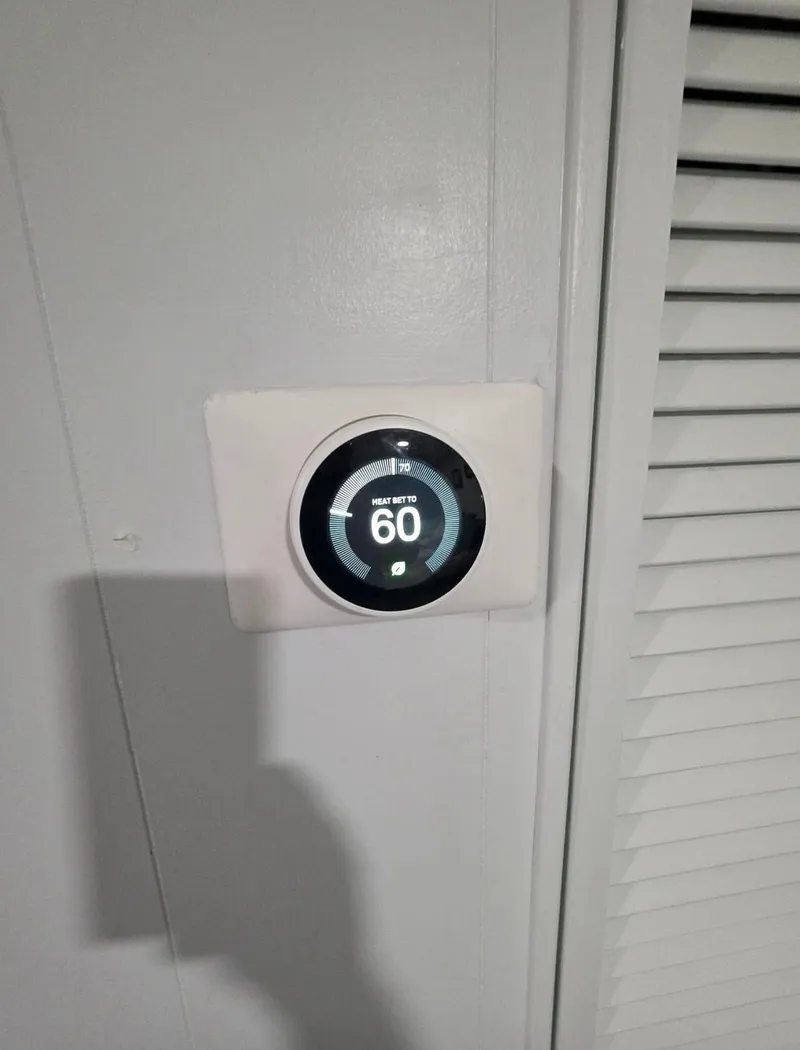 Slide: The Image of STARDUST 53 thermostat on wall set to 60 degrees. - 44