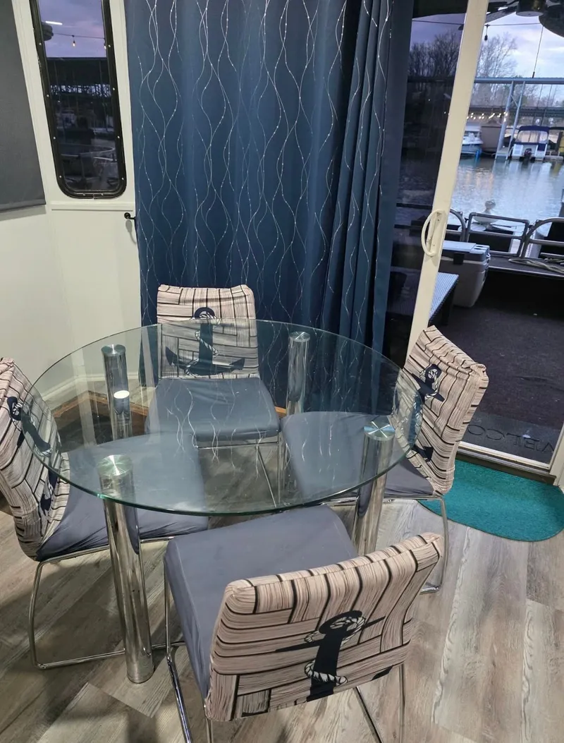 Slide: The Image of Glass table with four chairs in a 1992 STARDUST 53 boat. - 8