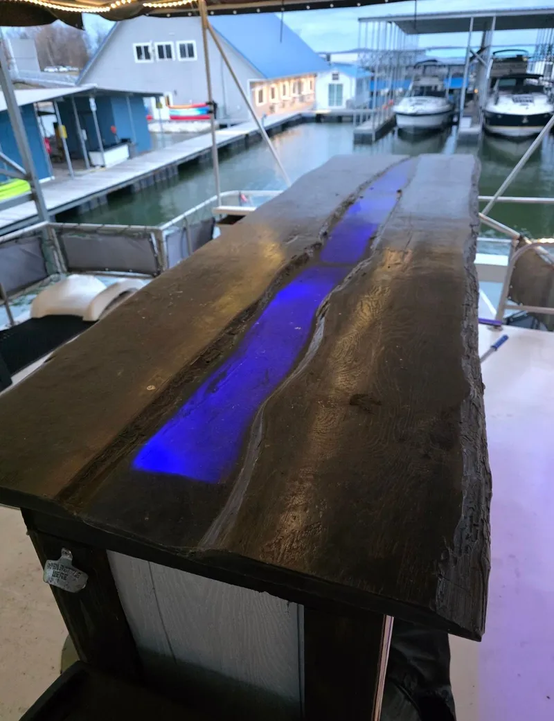 Slide: The Image of Wooden table with blue LED light, marina in background. - 9