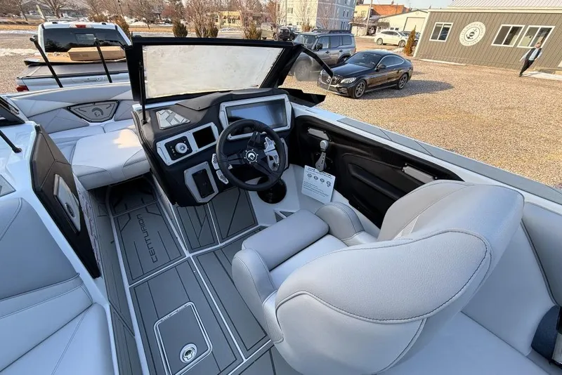 Slide: The Image of 2026 Centurion Nv233 boat interior with modern dashboard and steering wheel design. - 11