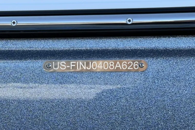 Slide: The Image of 2026 Centurion Nv233 boat hull identification number on metallic surface. - 15