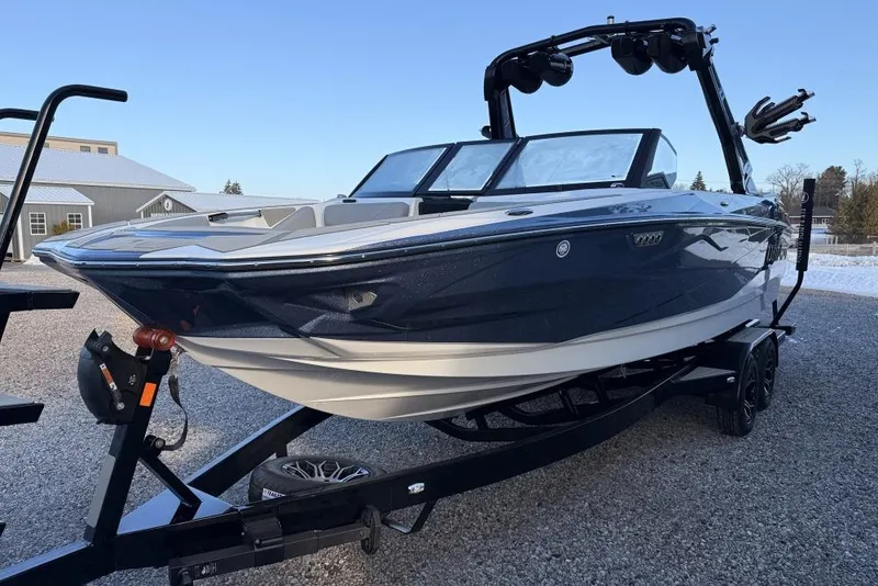 Slide: The Image of 2026 Centurion Nv233 boat on trailer, parked outdoors on gravel. - 7