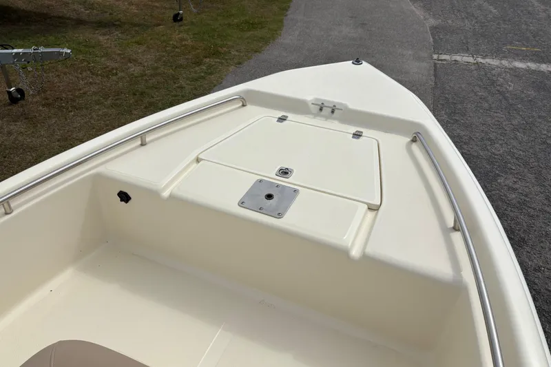 Slide: The Image of 2011 Scout 160 Sportfish boat deck with storage compartment and railing. - 17