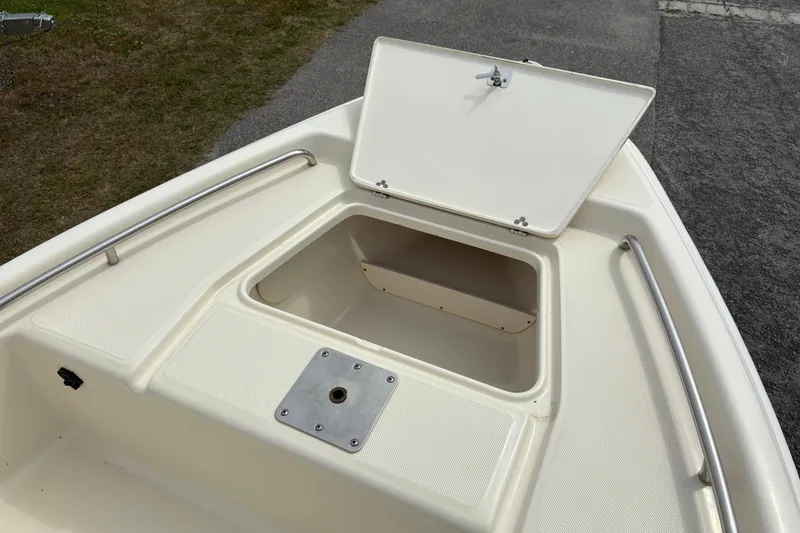 Slide: The Image of 2011 Scout 160 Sportfish boat with open storage compartment on deck. - 18