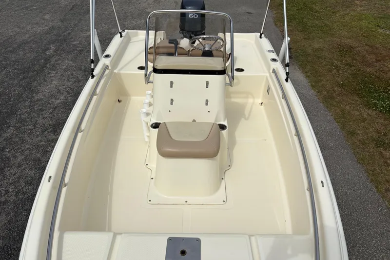 Slide: The Image of 2011 Scout 160 Sportfish boat interior with seating and steering console. - 19