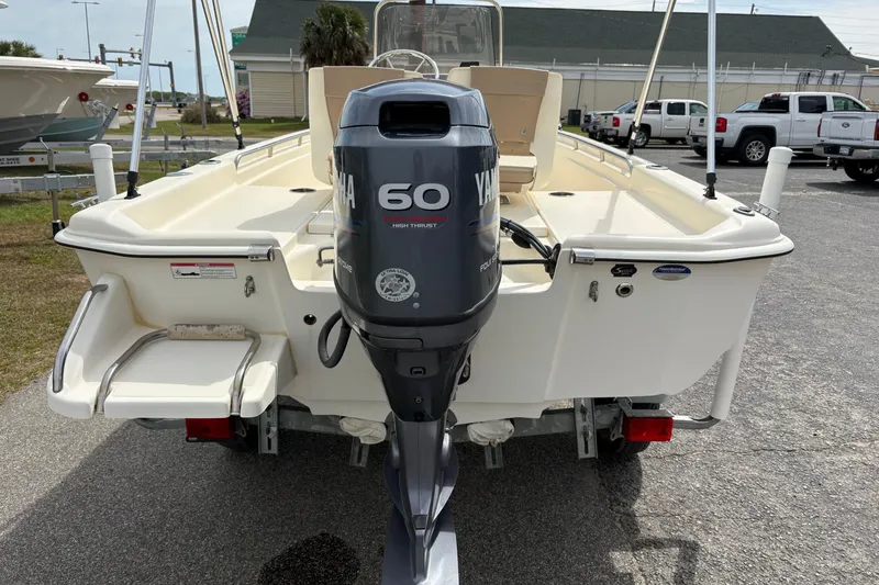 Slide: The Image of 2011 Scout 160 Sportfish boat with Yamaha 60 outboard motor, parked on trailer. - 2