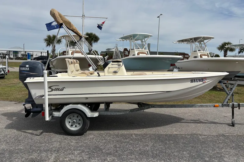 Slide: The Image of 2011 Scout 160 Sportfish boat on trailer with Yamaha engine, parked outdoors. - 4