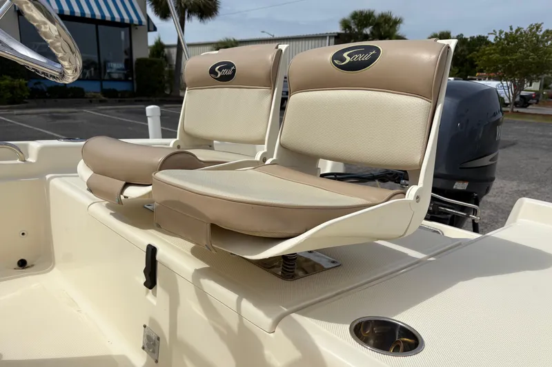 Slide: The Image of 2011 Scout 160 Sportfish boat seats with beige upholstery and logo. - 8