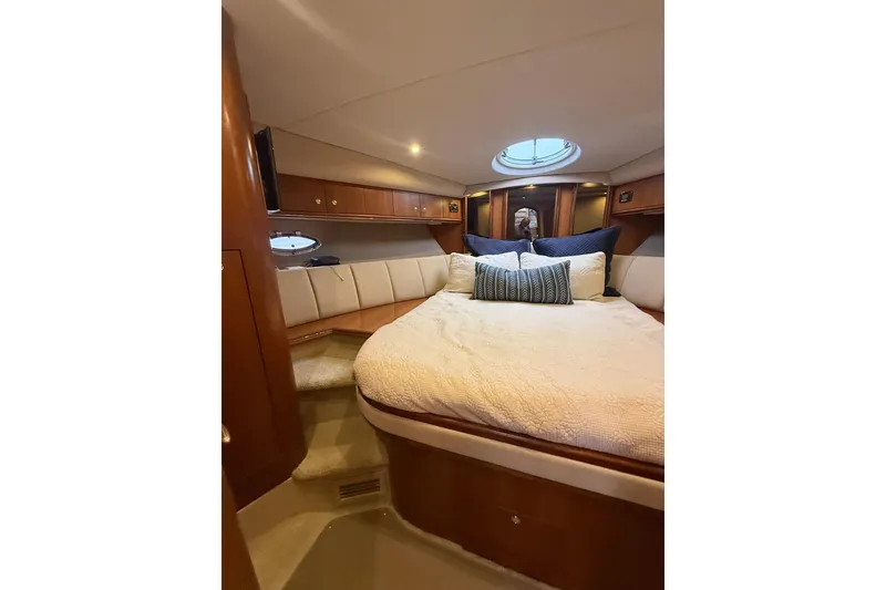 Slide: The Image of Luxurious cabin interior of 2001 Cruisers Yachts 4450 Express Motoryacht with plush bedding. - 16