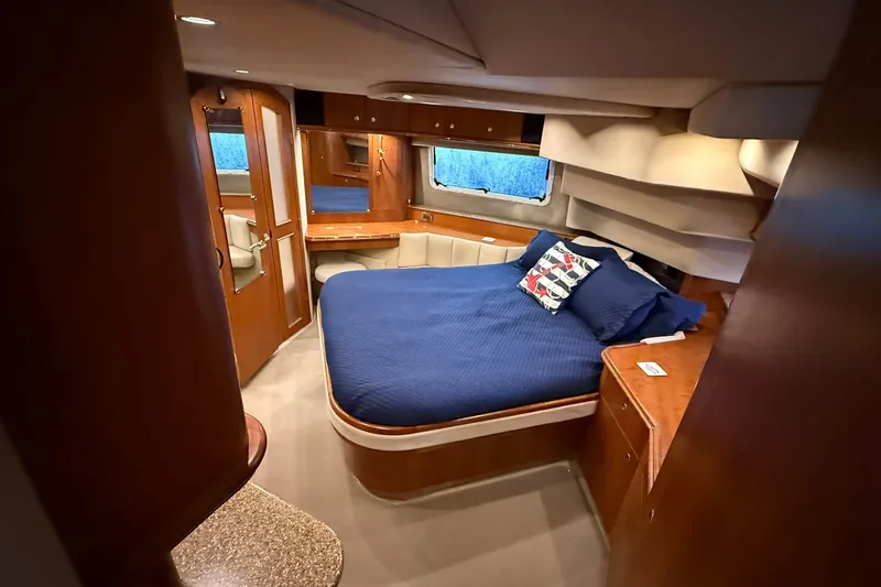 Slide: The Image of Luxurious cabin interior of 2001 Cruisers Yachts 4450 Express Motoryacht with blue bedding. - 21