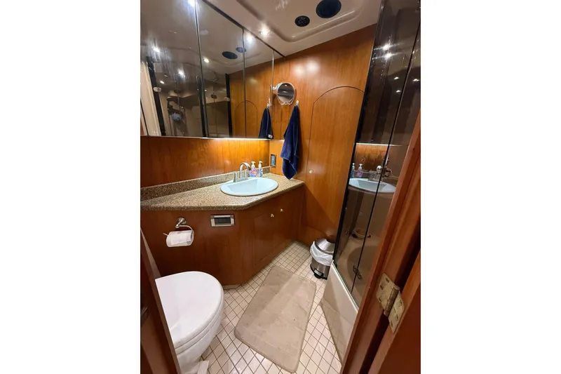 Slide: The Image of Luxurious bathroom in 2001 Cruisers Yachts 4450 Express Motoryacht with wood accents and modern fixtures. - 24