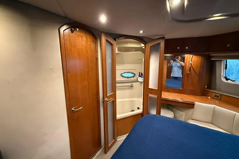 Slide: The Image of Interior of 2001 Cruisers Yachts 4450 Express Motoryacht with wooden cabinetry and cozy seating. - 25