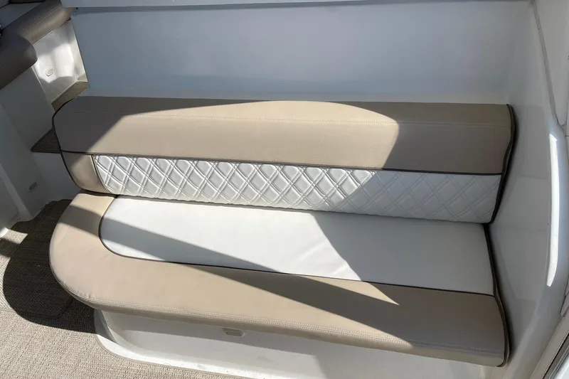 Slide: The Image of Beige and white cushioned seating on 2001 Cruisers Yachts 4450 Express Motoryacht. - 5